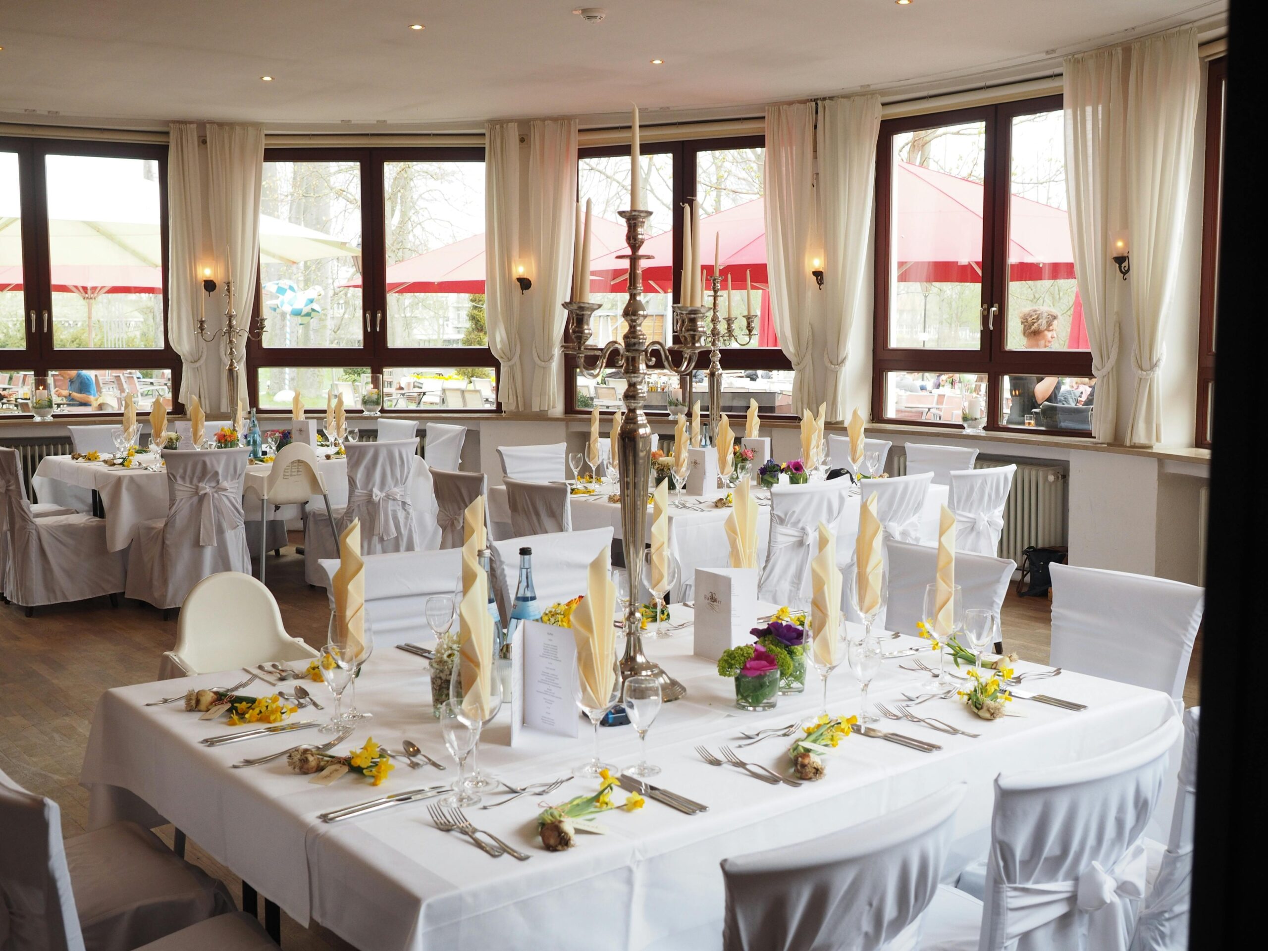 A beautifully arranged dining room with elegant table settings ready for a special event or celebration.